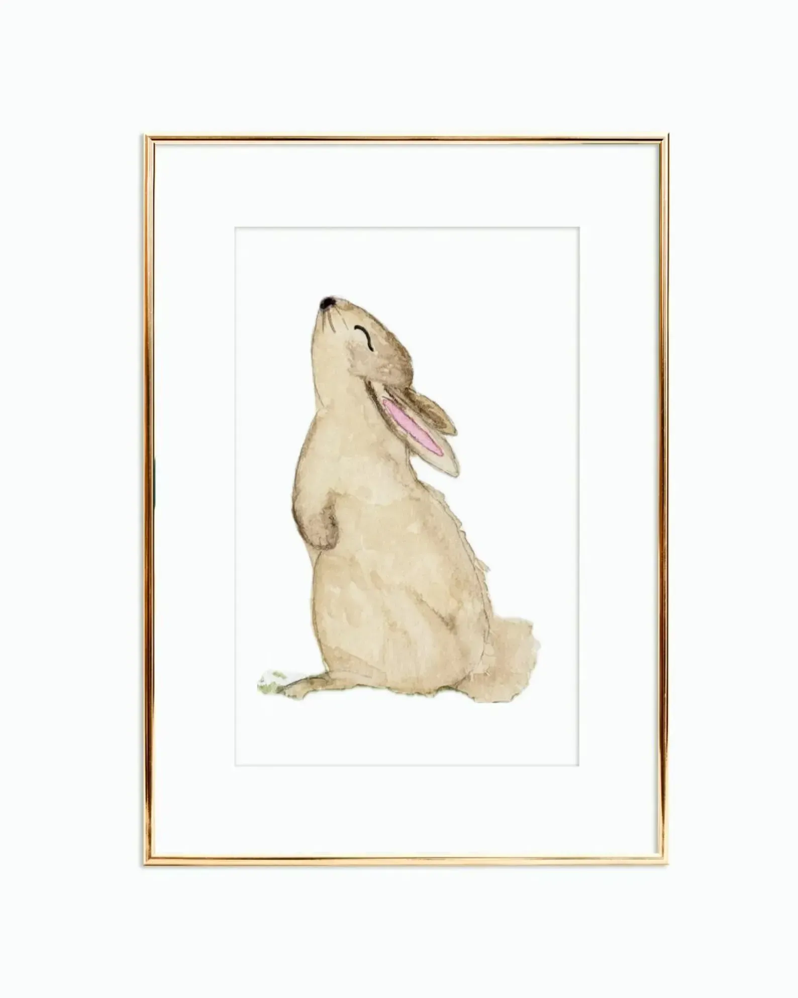 Watercolor painting of a bunny with closed eyes, facing up, in a gold frame.