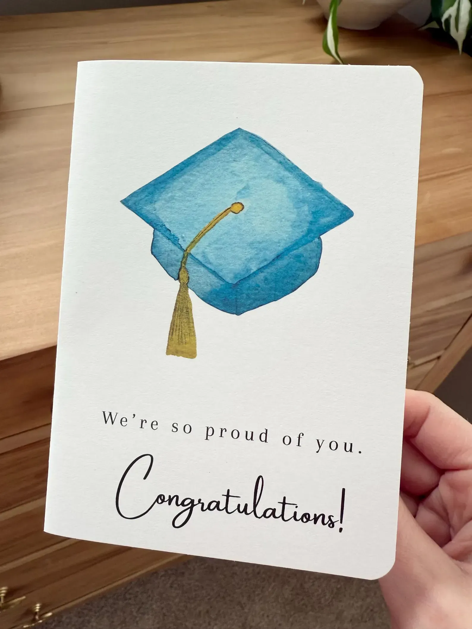 Graduation card with blue mortarboard and “Congratulations!” text