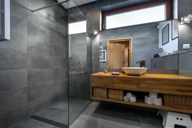 10mm Frameless shower screen with brace to tiled wall in contemporary bathroom with timber vanity