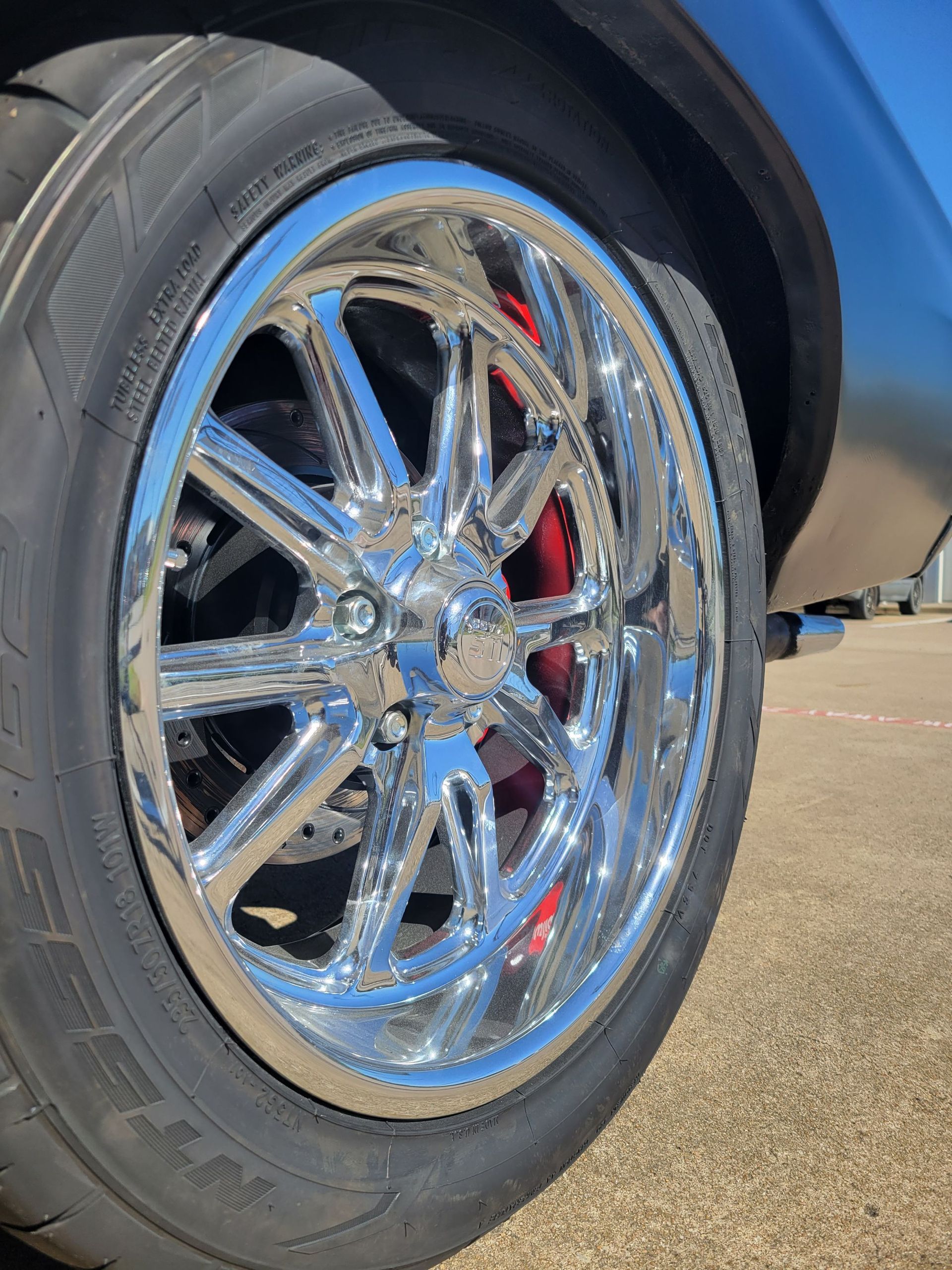 a close up of a chrome wheel on a car