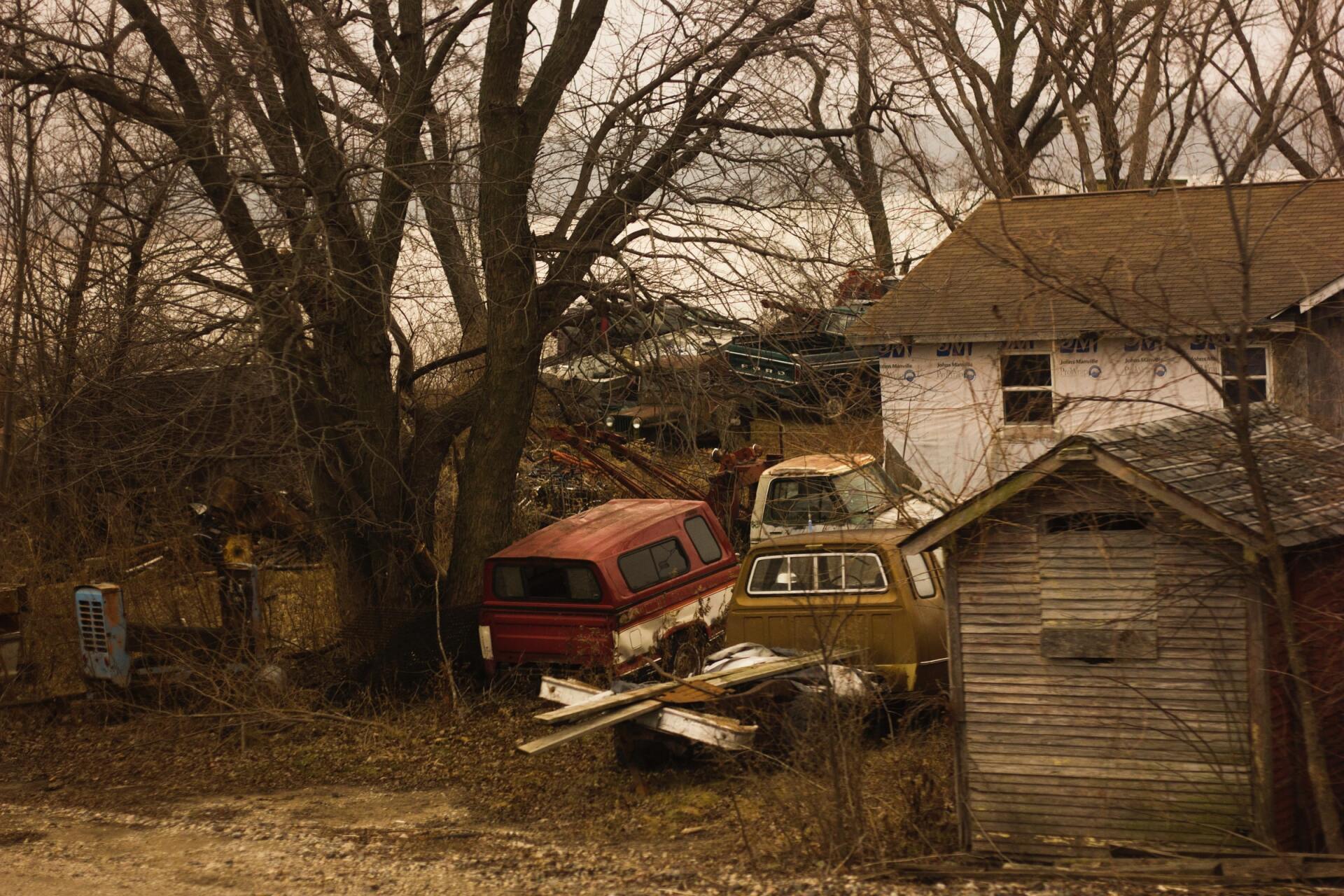 junk vehicles near house