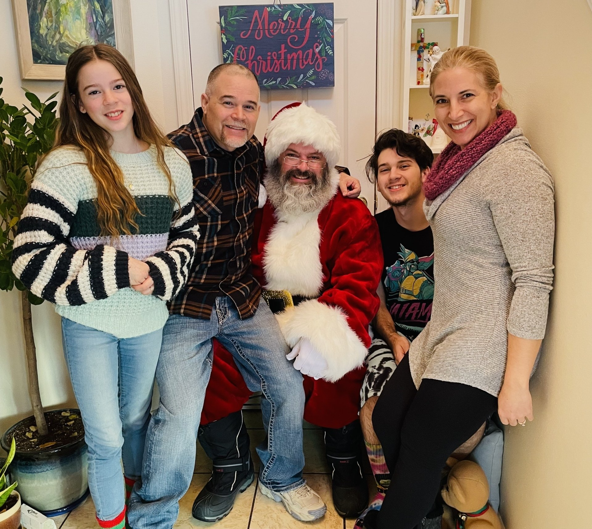 a group of people posing for a picture with santa claus