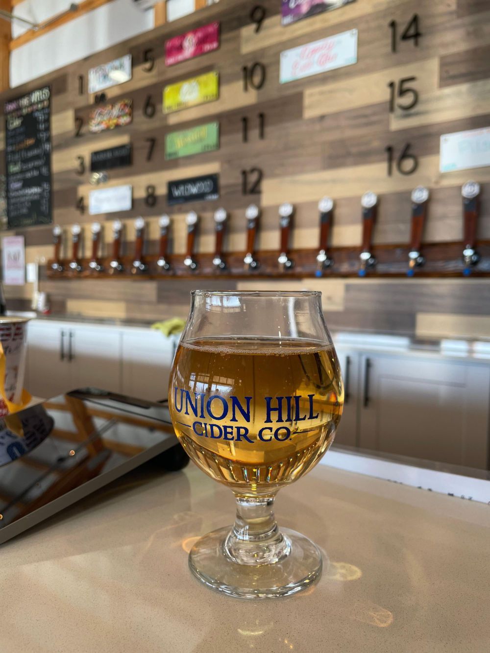 A glass of union hill cider on a table