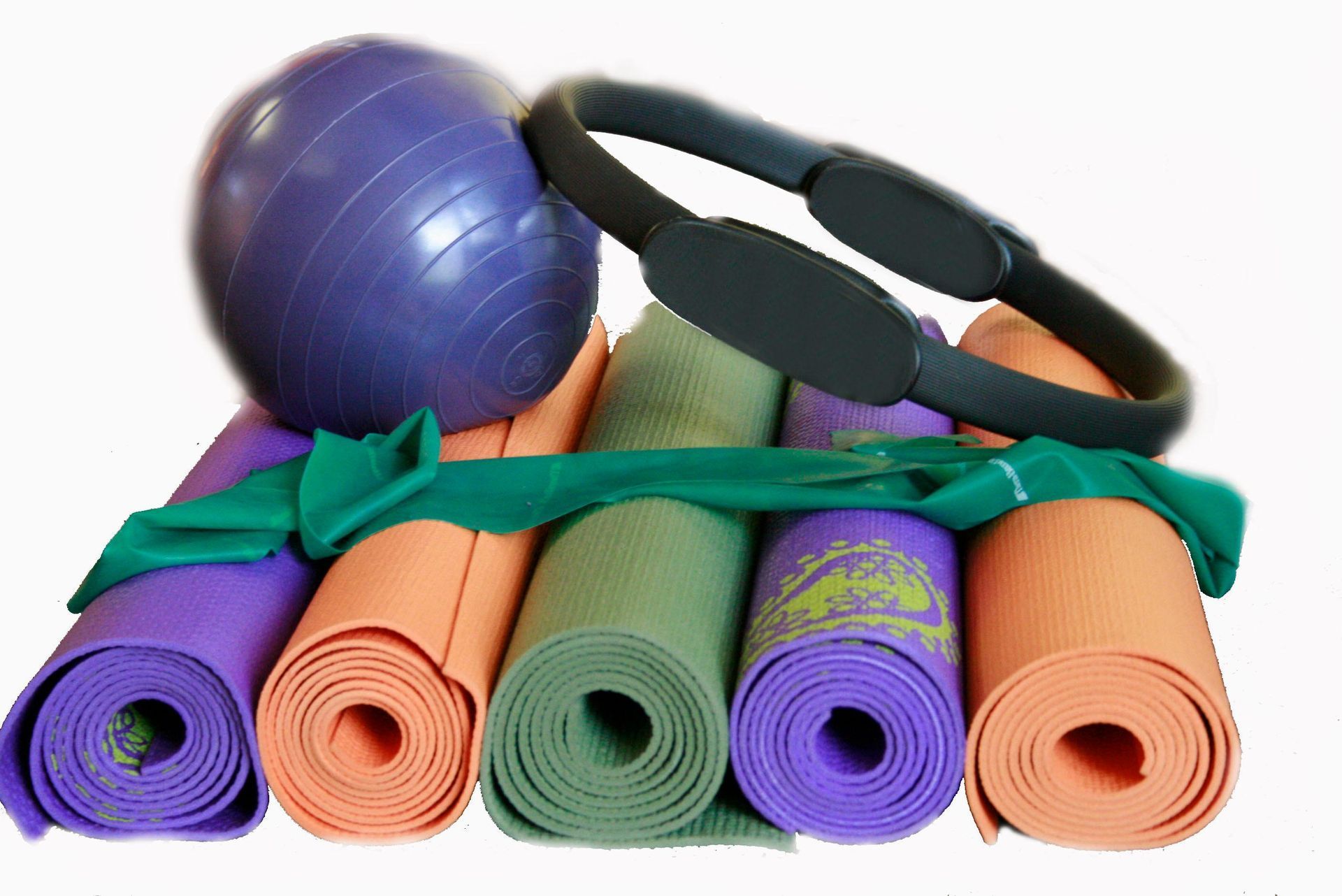 Fitness gear: rolled yoga mats, stability ball, resistance bands, and foam rollers on white background