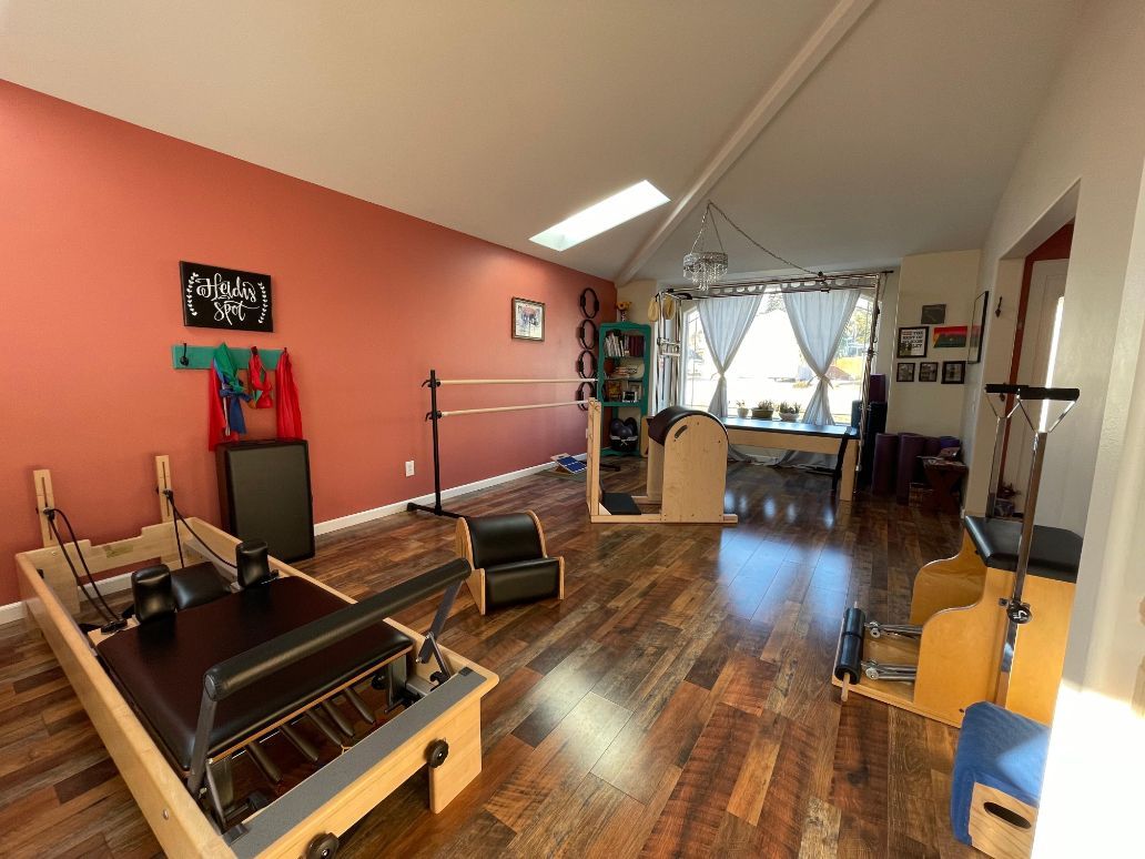 there is a pilates machine in the middle of the room .