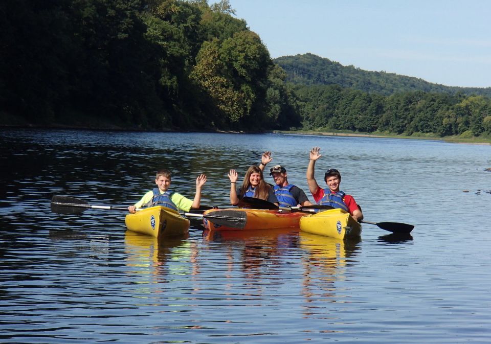 A group of people are in kayaks on a lake. A group of people are in kayaks on a lake.