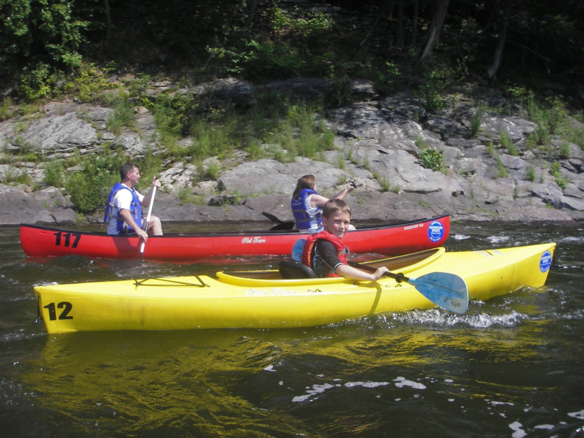 A yellow kayak  at adventure sports with the number 12 on it