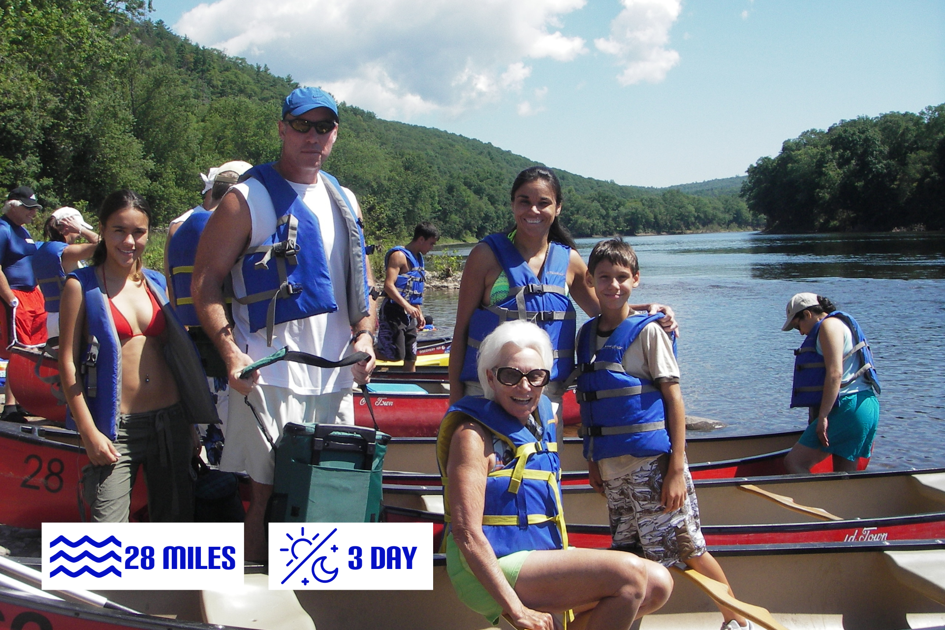 A group from Adventure Sports are kayaking down a river.
