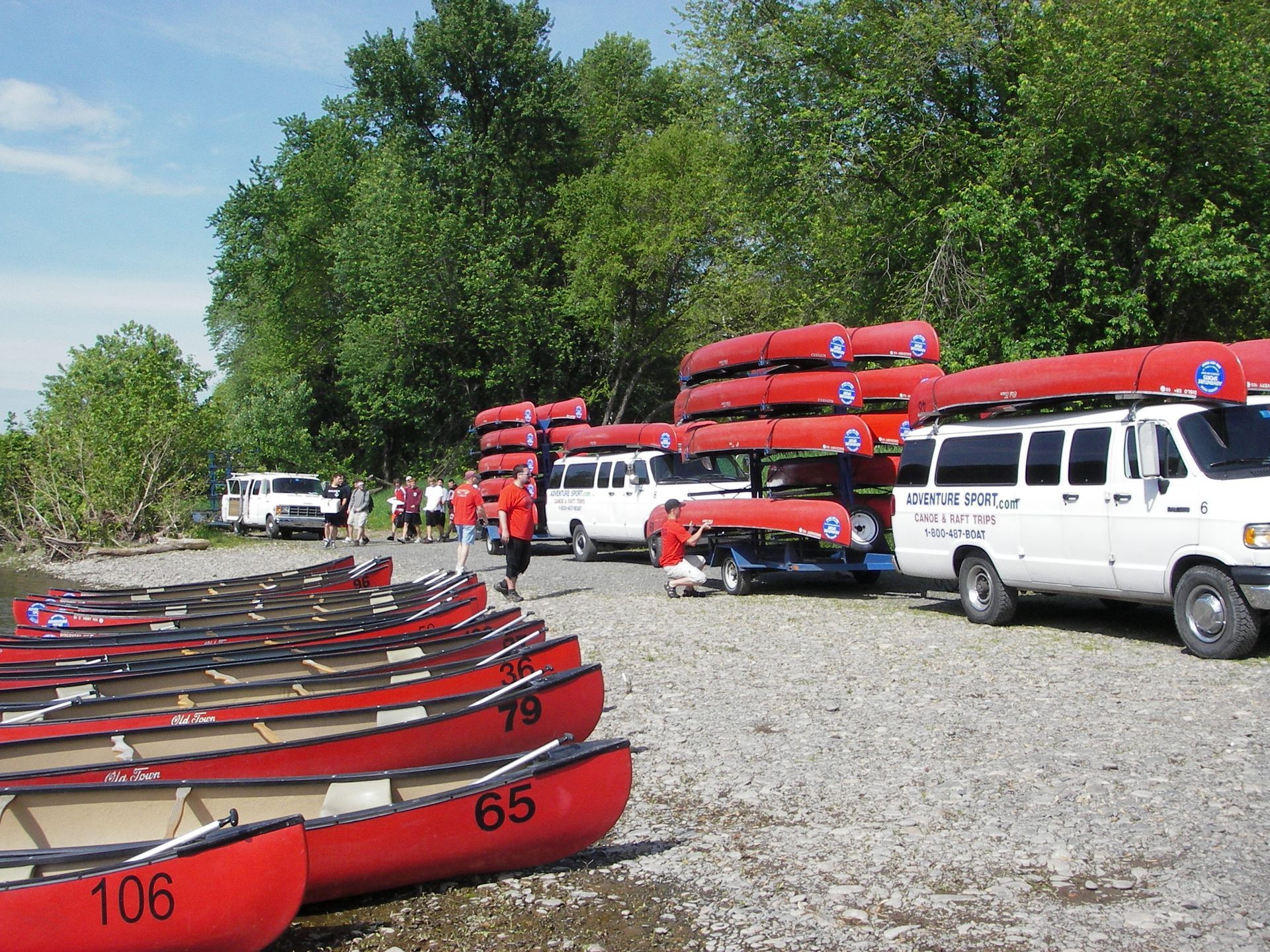 A row of red adventure sports canoes with the number 106 on them