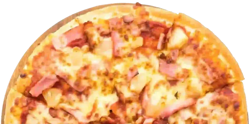 A Hawaiian pizza with pineapple chunks and ham on a light-colored, thin crust.