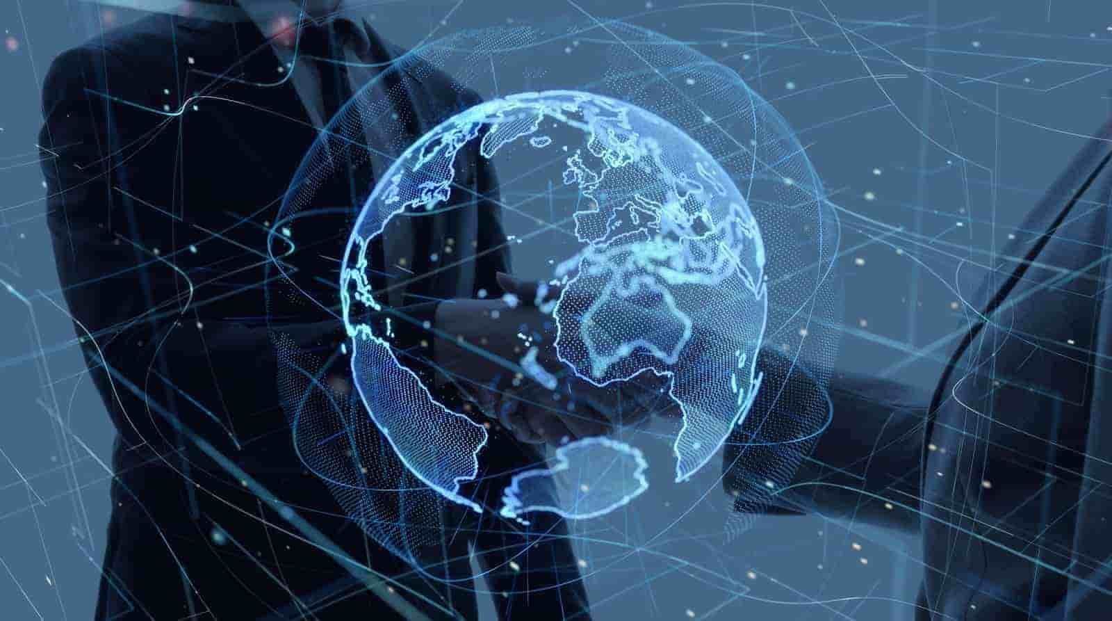 Two business professionals shaking hands, overlaid with a glowing blue digital globe.