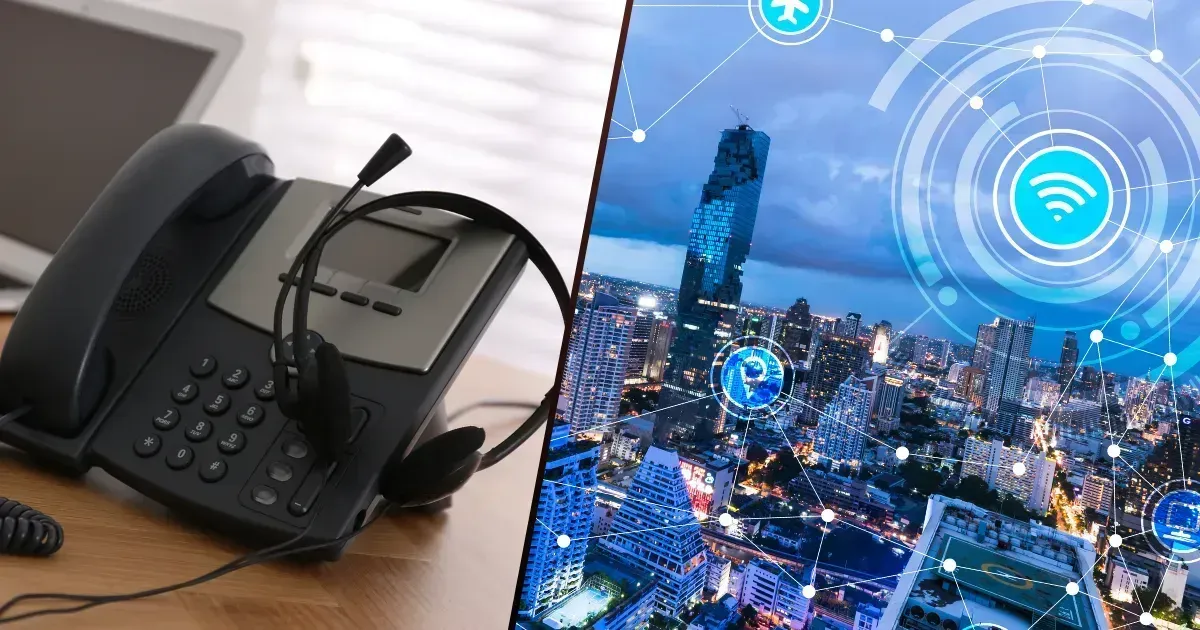 A desk phone with a headset sits next to a digital overlay of a city connected by a network.