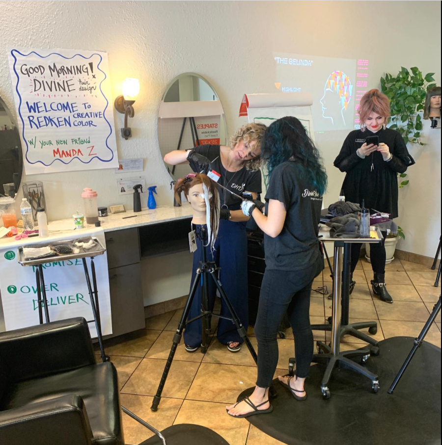 Haircuts in progress at a salon, with stylists working around mirrors and equipment.