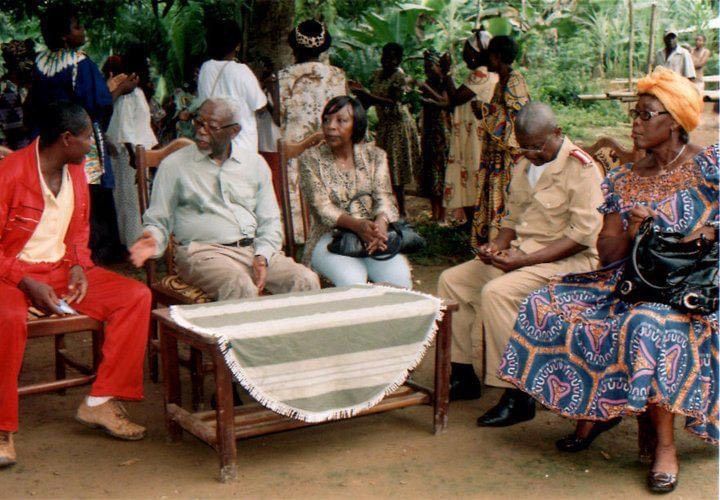 A group of people are sitting around a table outside