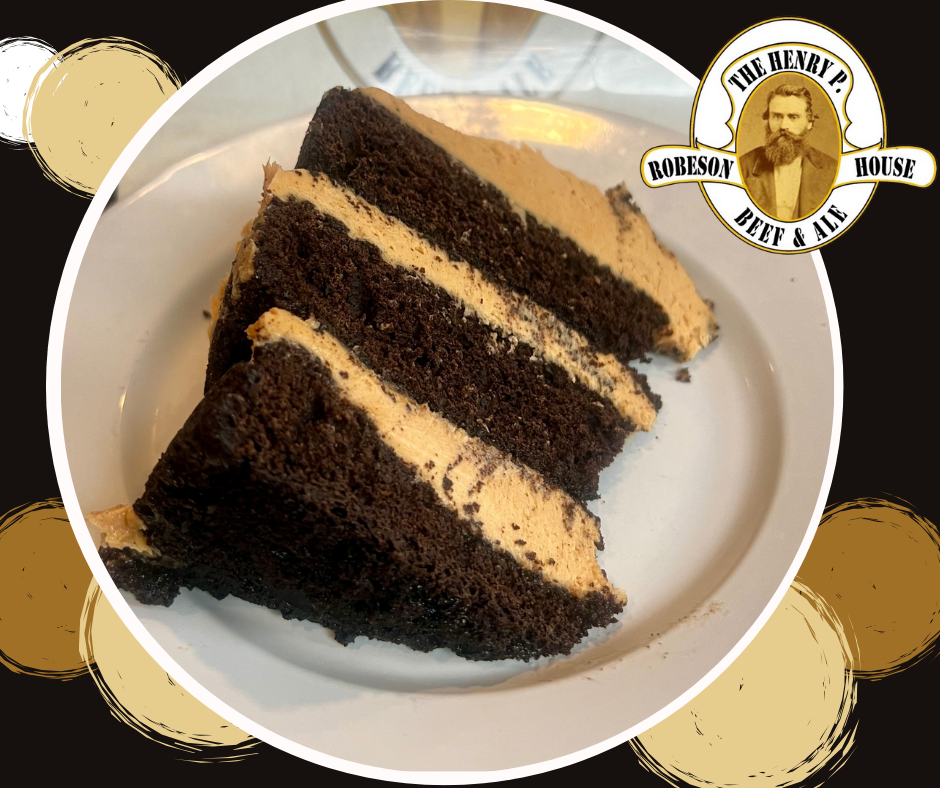 Three slices of dark chocolate cake on a white plate, with a bakery logo in the corner.