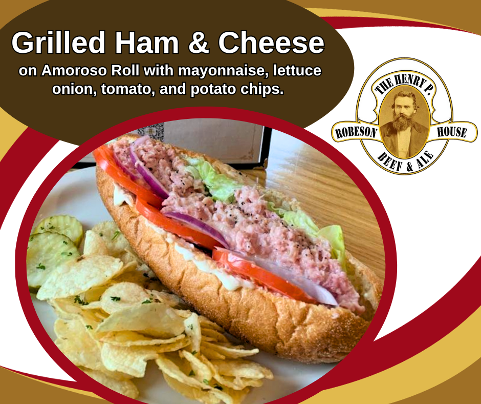 Grilled ham and cheese on a roll with lettuce, tomato, onion, and chips on a red-and-gold menu graphic