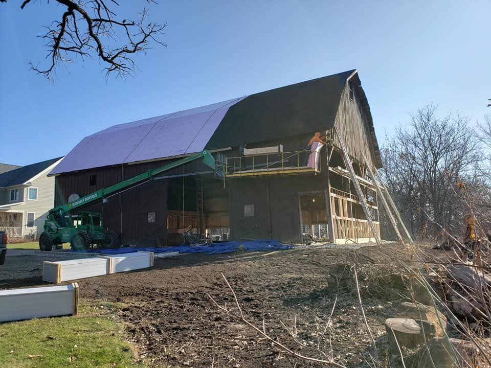 Historic barn restoration in Beloit, WI with exterior repairs and roofing work by Above The Peak