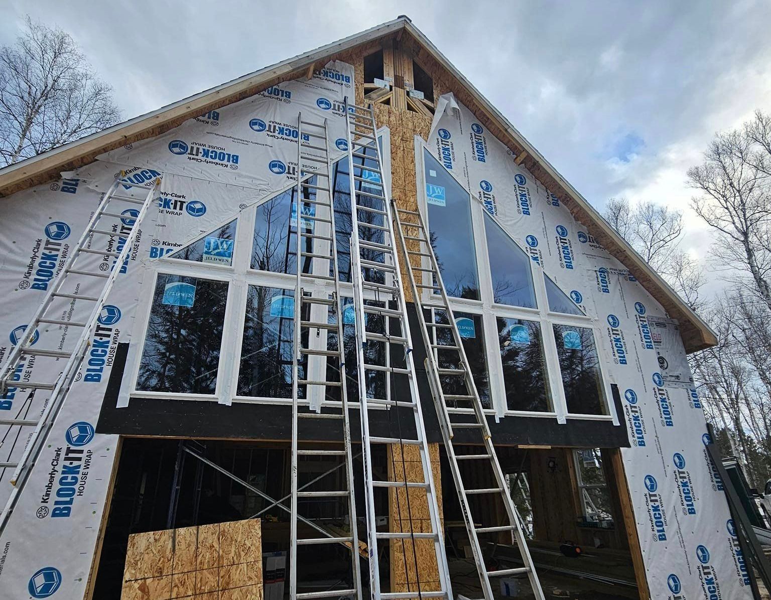A large house with a lot of windows is being built.