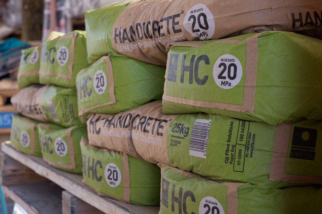 A stack of green 25kg Handicrete bags featuring