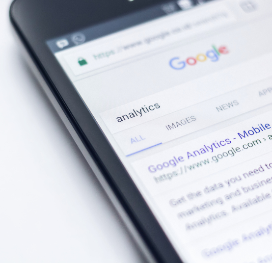 A close-up view of a smartphone screen displaying a Google search results page for the term