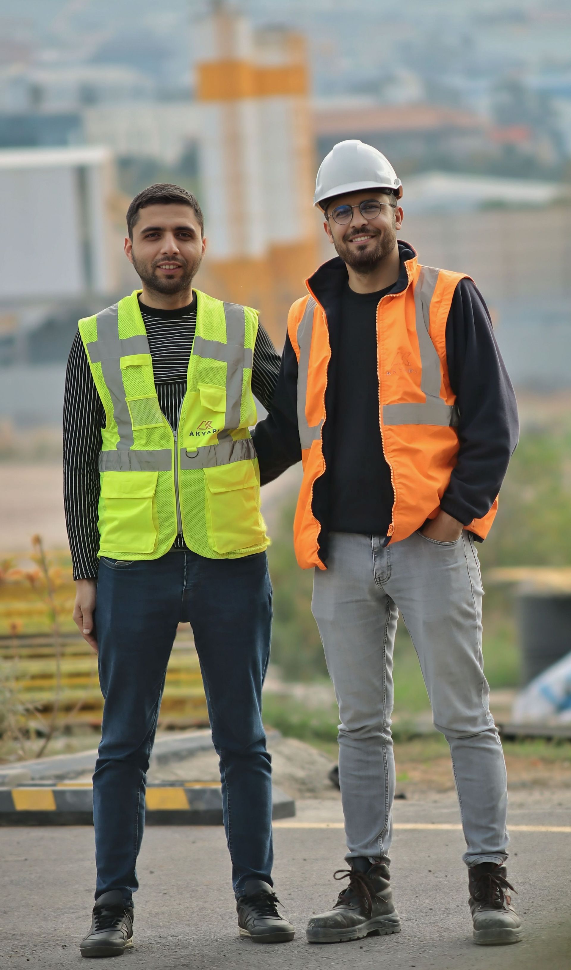 Two construction workers in safety vests and hard hats – accommodation for teams and workers