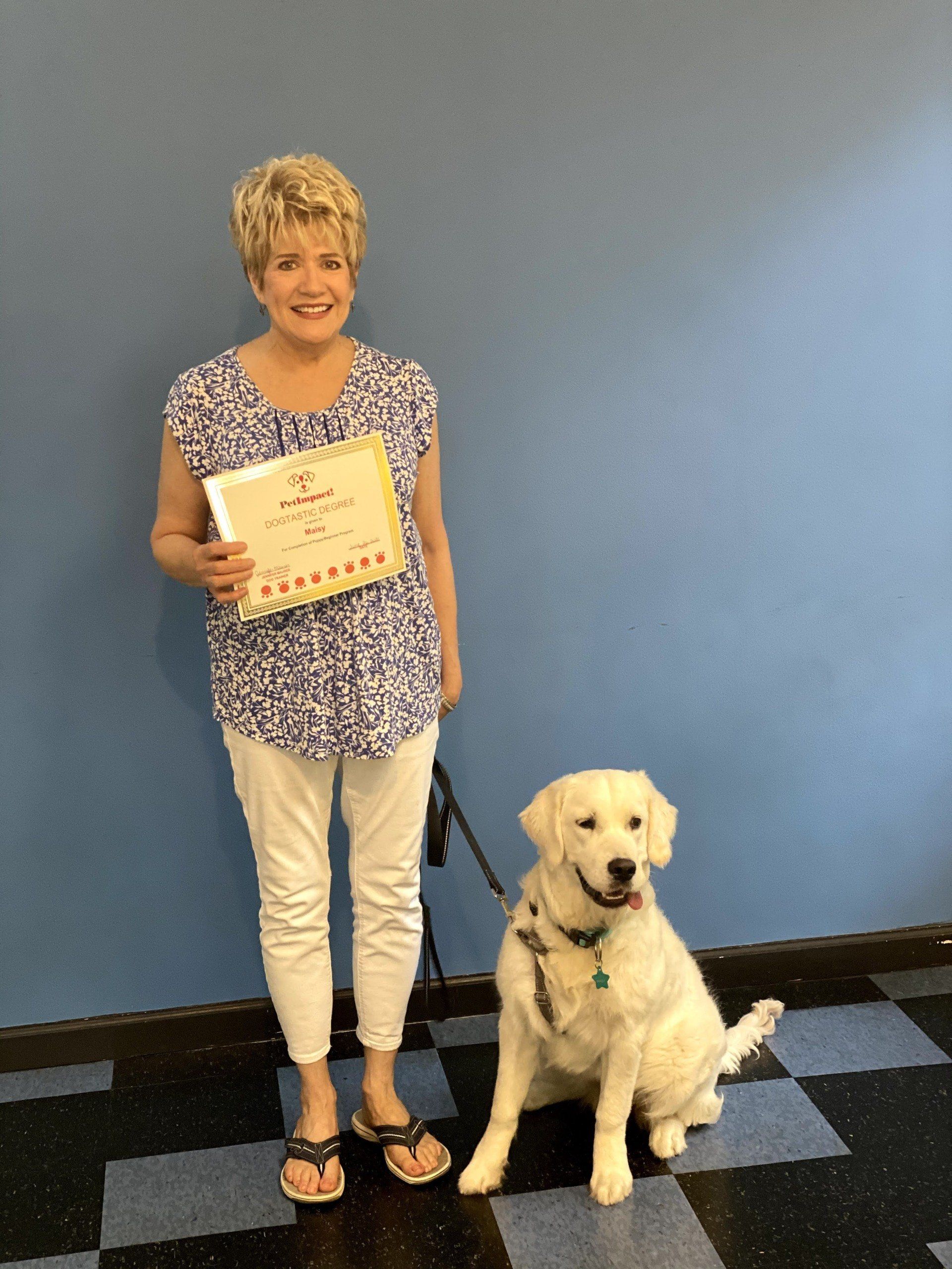 Dog Maisy With Its Owner Holding Certificate — St. Louis, MO — PetImpact!