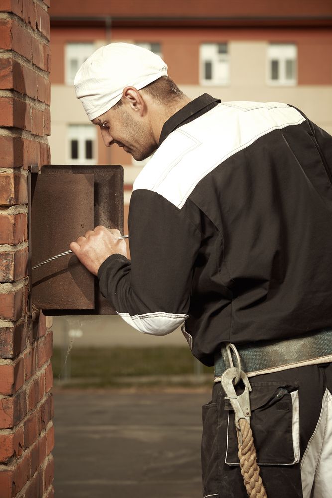 man pulling wire inside the chimney