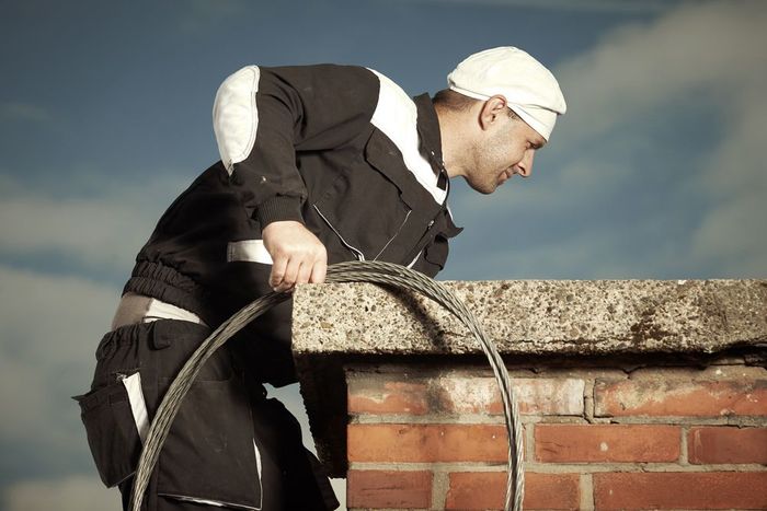 man looking inside the chimney