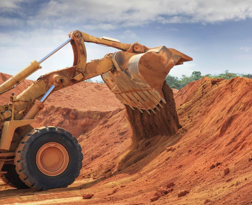A Bulldozer Is Digging A Hole In The Dirt — Dubbo Hardcore Soils & Earthmoving In Dubbo, NSW