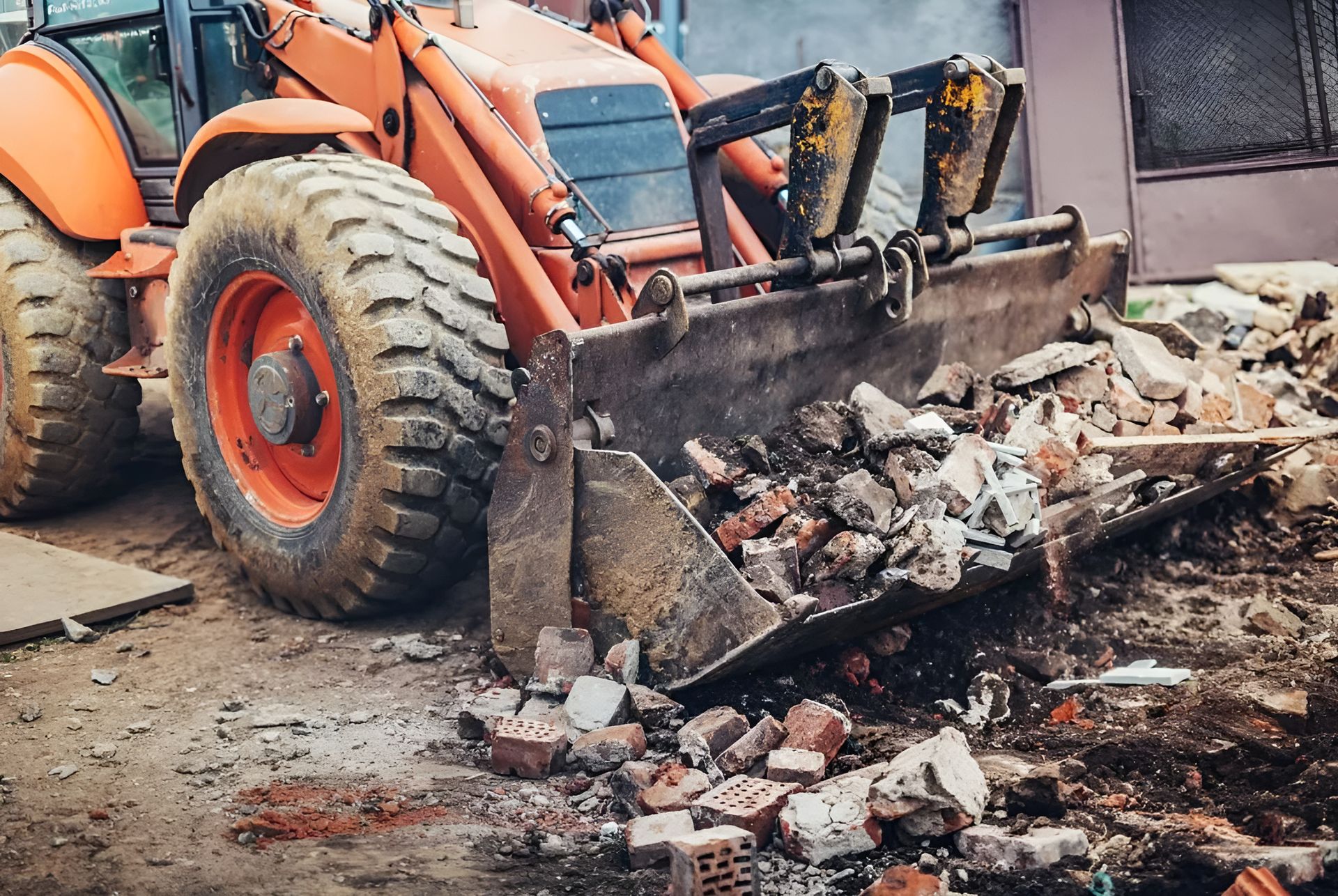 A Bulldozer Is Destroying A Building With A Bucket Full Of Bricks — Dubbo Hardcore Soils & Earthmoving In Dubbo, NSW