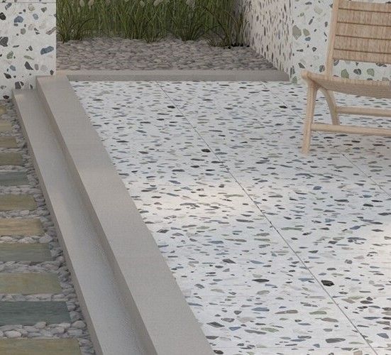 A chair is sitting on a tiled floor next to a wall.