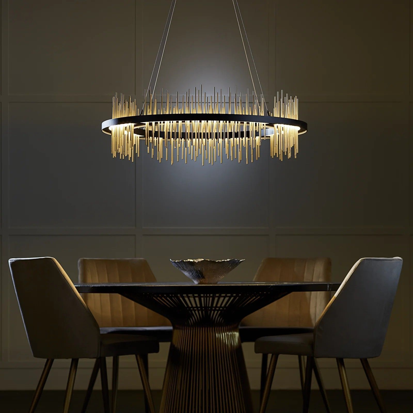A dining room with a table and chairs and a chandelier hanging from the ceiling