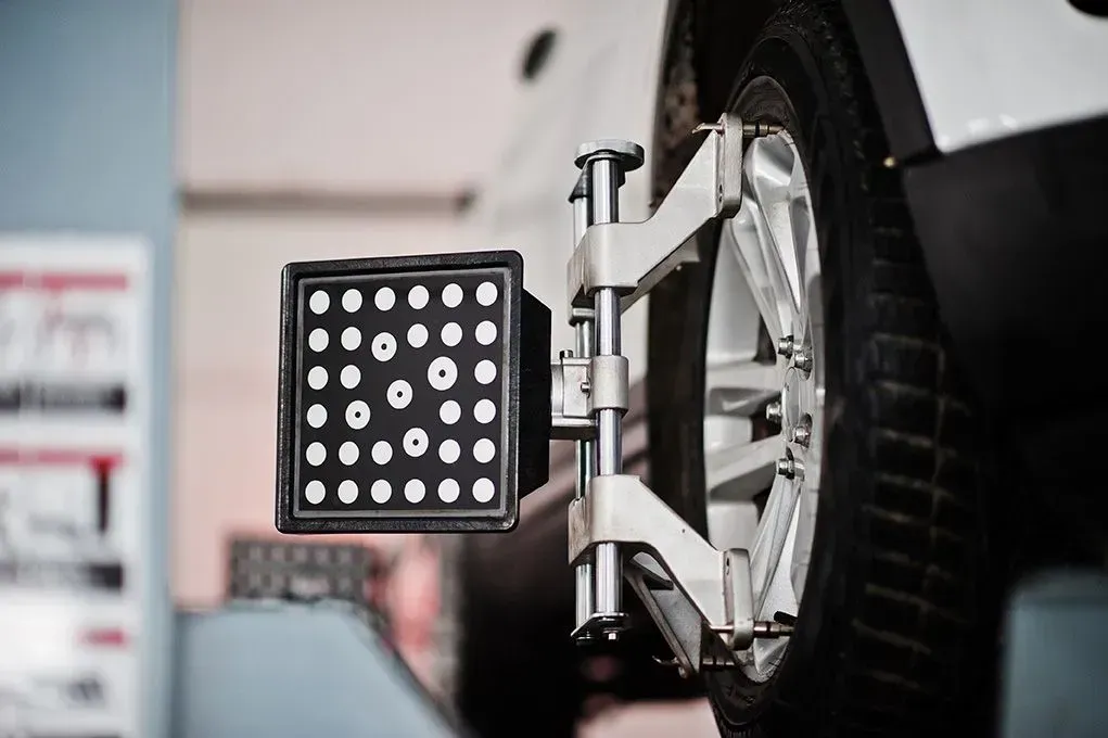 A close up of a wheel alignment machine on a car.