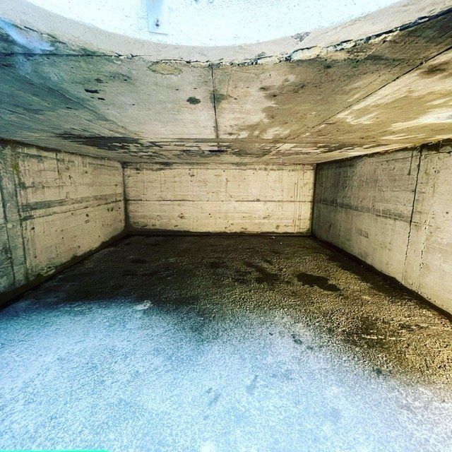 Une pièce vide avec des murs en béton et un plafond