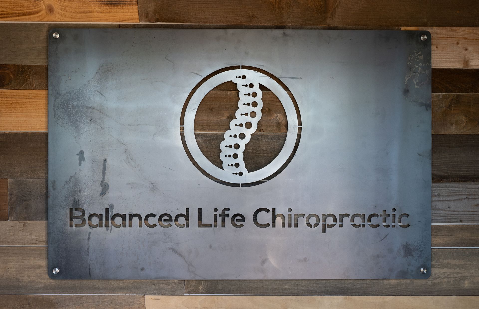 Metal Board that has the Balanced Life Chiropractic logo