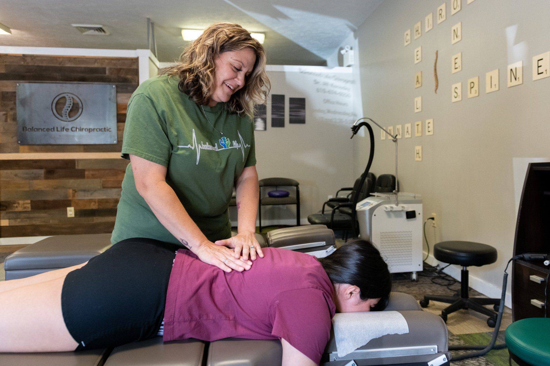 A woman is giving a woman a massage on a table.