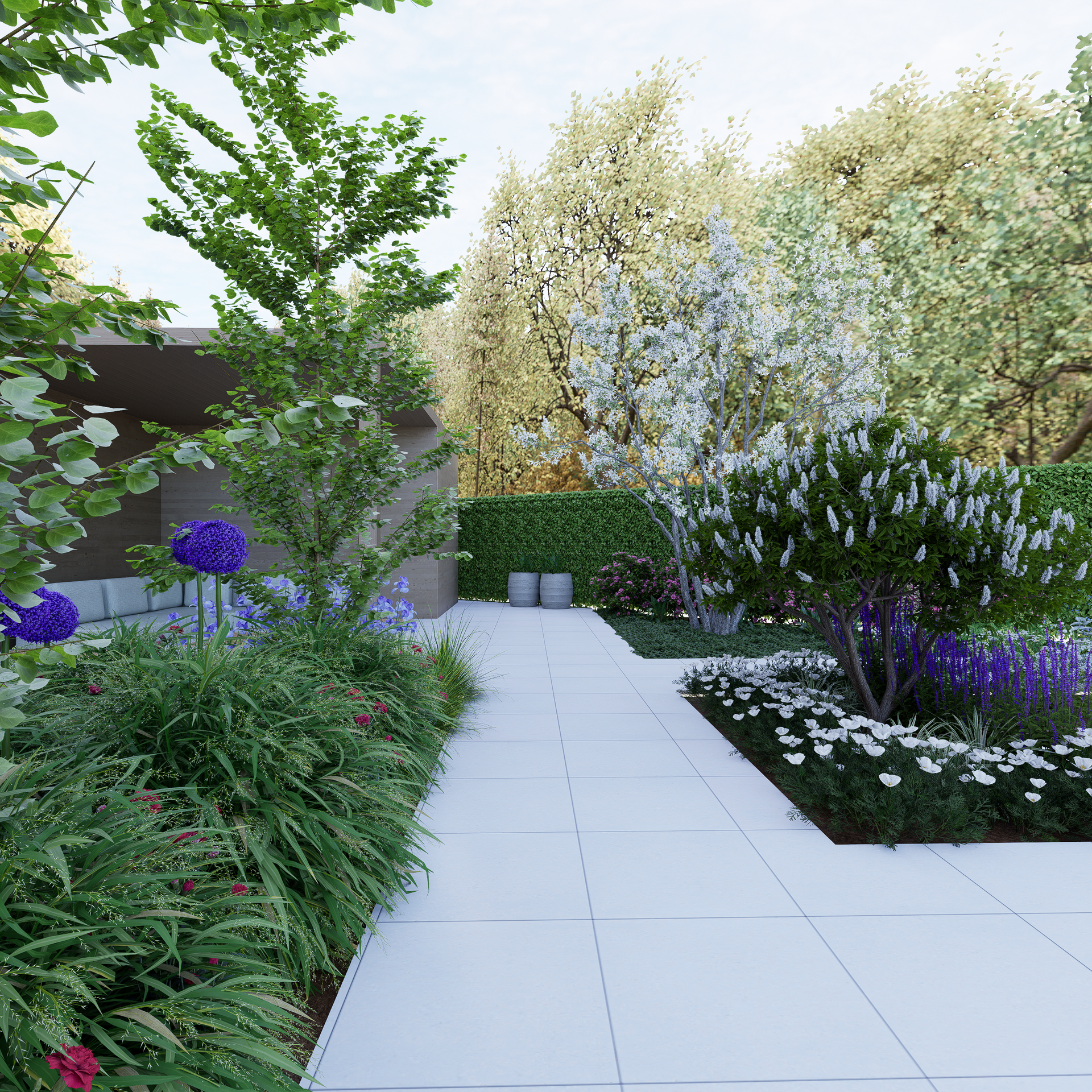 Garden with white stone path, various plants, and a backdrop of trees.