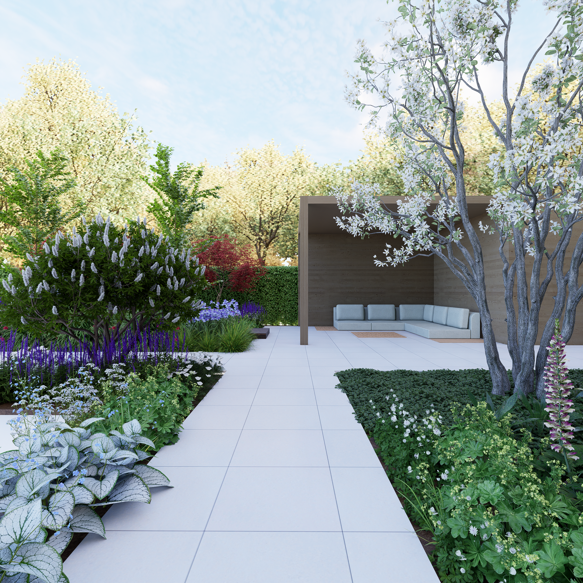 A modern garden with white stone path, seating area, and lush green and flowering plants.