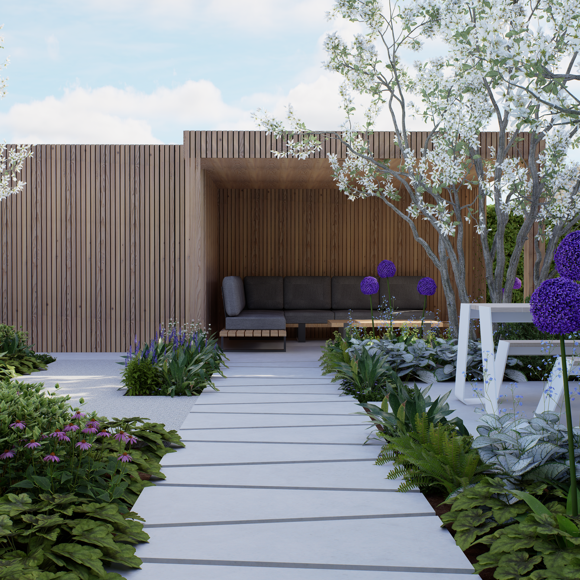 Stone path leads to a wooden structure with seating, surrounded by a garden with flowers and trees.
