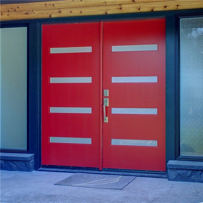 Red double front doors with horizontal silver accents in a building entrance.