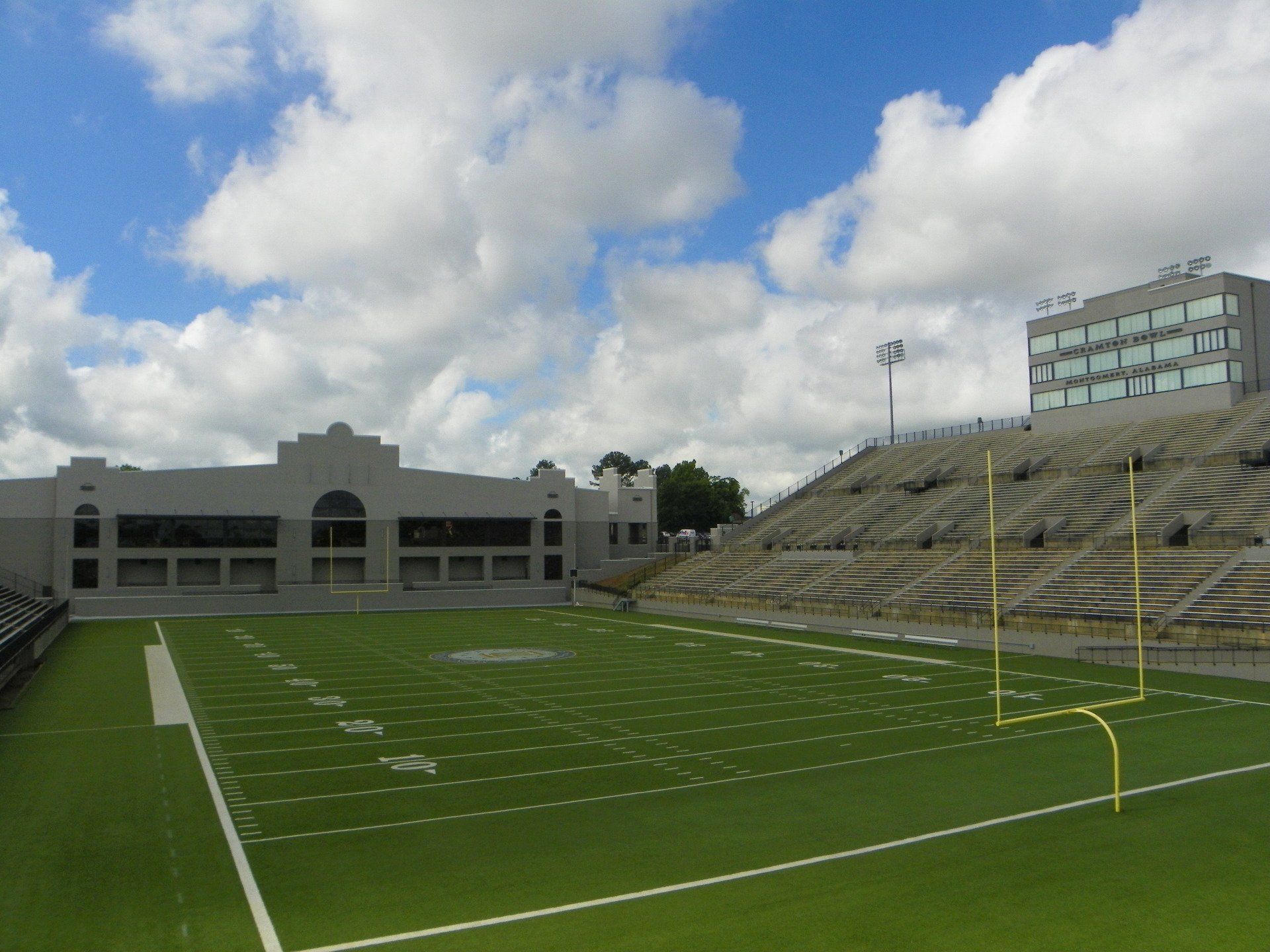 An empty football field with a building in the background