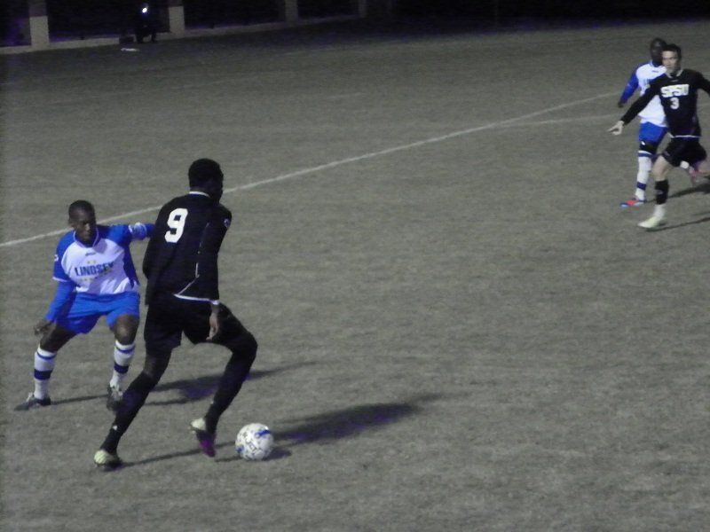 A soccer player with the number 9 on his back