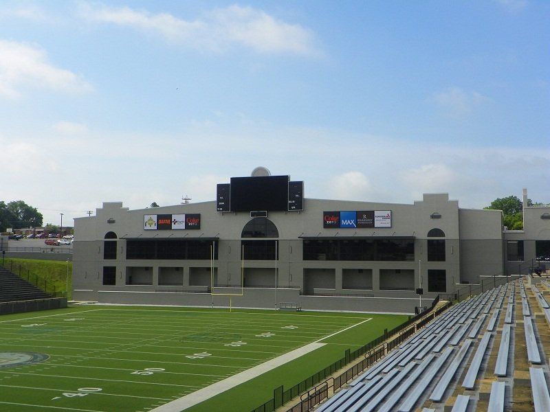 A football stadium with a large screen on top of it