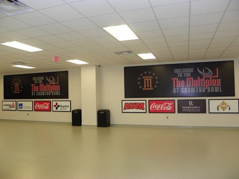 A large room with a coca cola sign on the wall