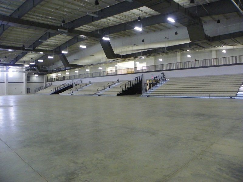 A large empty stadium with bleachers and stairs