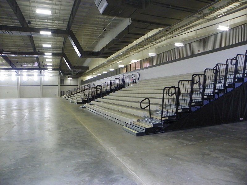 A large empty stadium with bleachers and stairs
