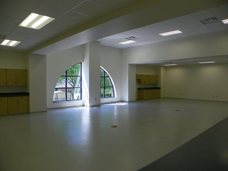 A large empty room with a lot of windows