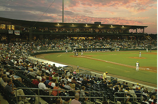 A baseball stadium filled with people watching a game