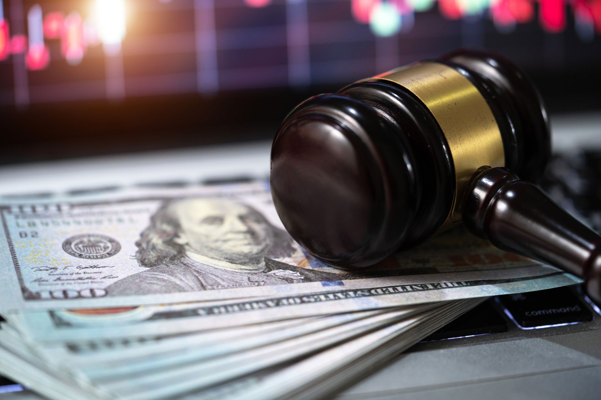 A judge 's gavel is sitting on top of a stack of money.