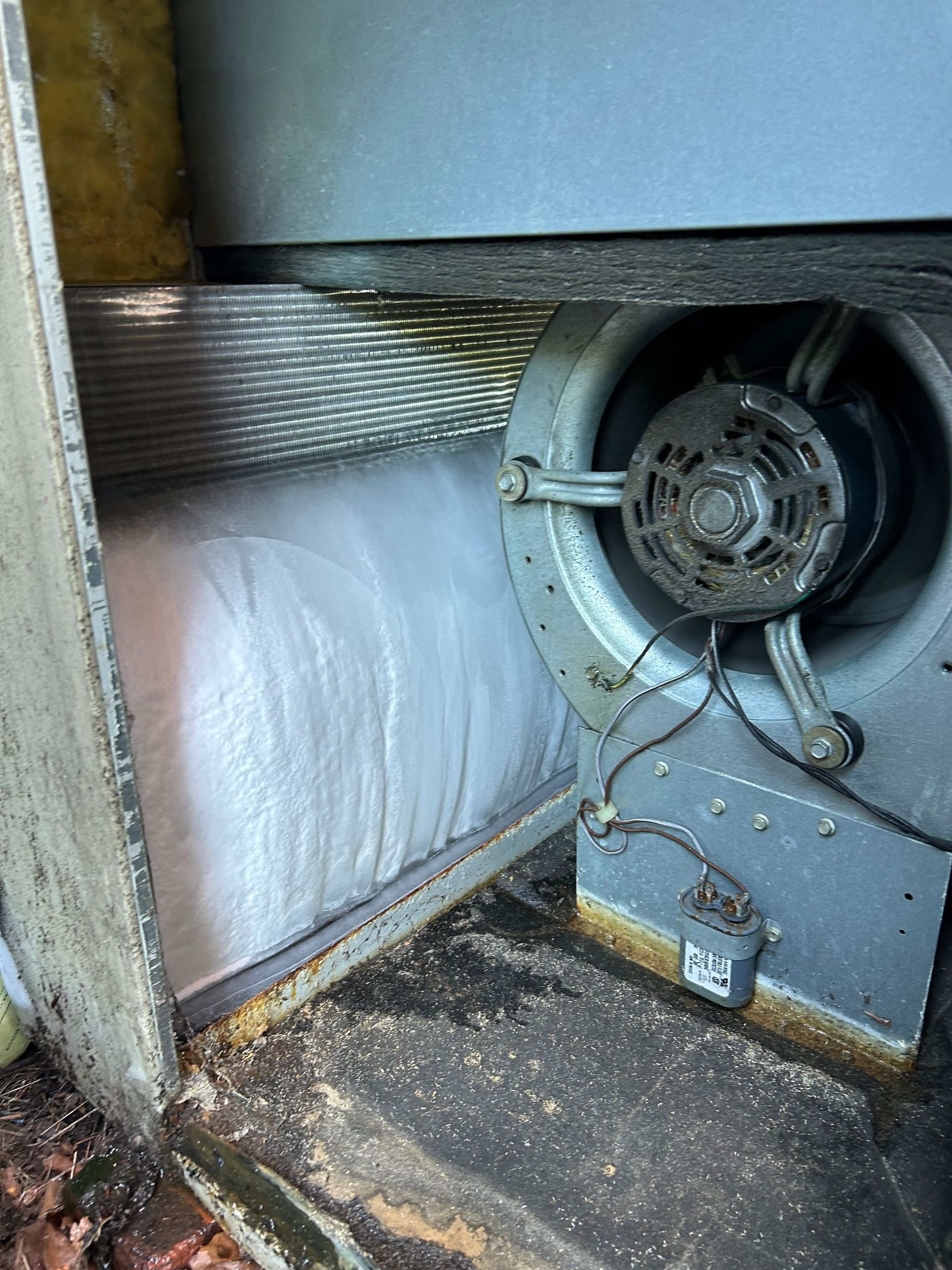 Industrial fan and ductwork inside a dusty ventilation compartment